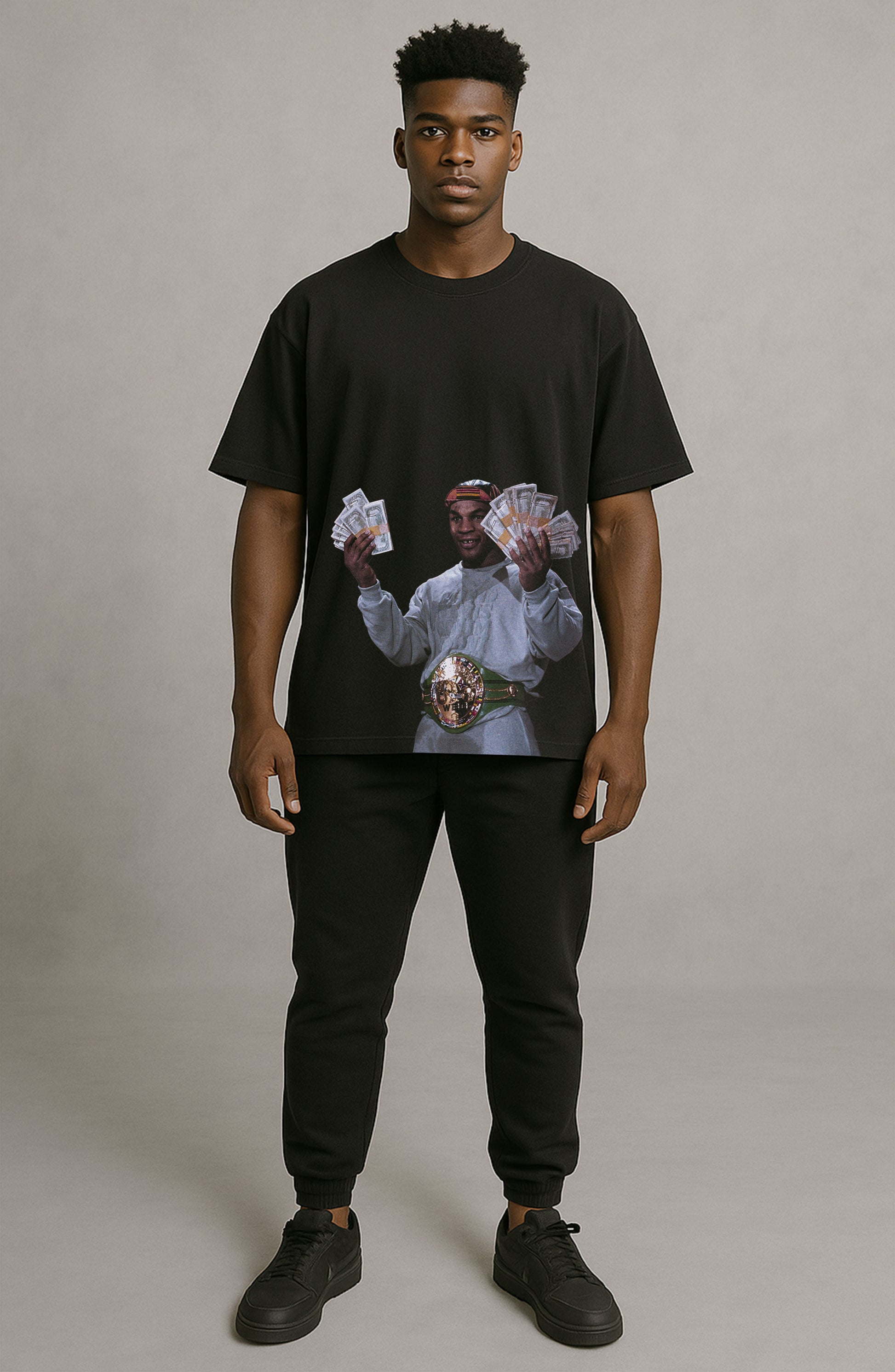 Person wearing a black t-shirt with a graphic design on a plain background